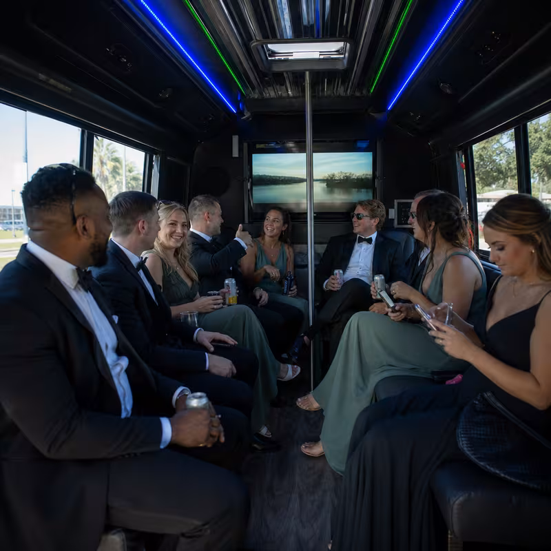 Wedding guests seated inside a New Orleans party bus