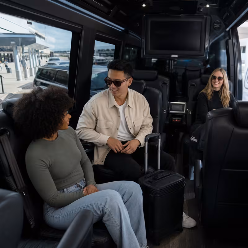 Passengers loading luggage while boarding an New Orleans group shuttle
