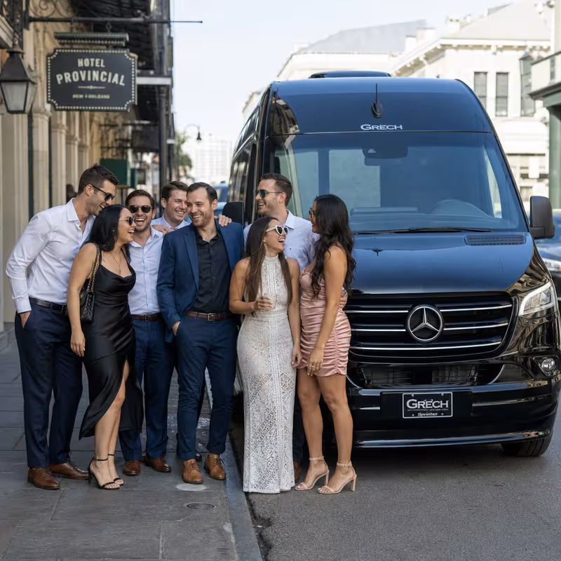 Group boarding a white charter bus for Bachelor & Bachelorette Transportation transportation in New Orleans