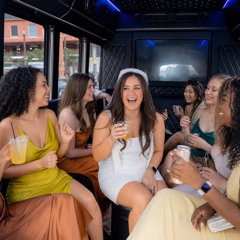 Party bus interior with wraparound leather seating and LED lighting in New Orleans