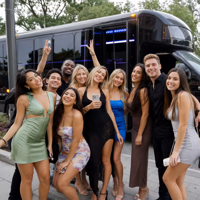 Group boarding a white charter bus for Birthday Transportation transportation in New Orleans