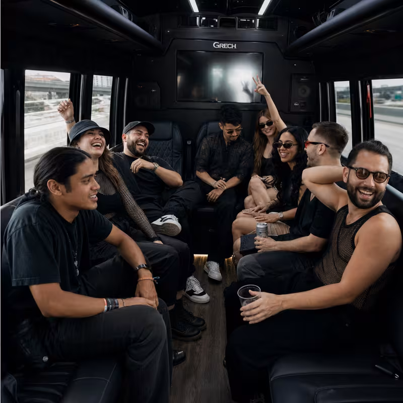 Group boarding a white charter bus for Concert Transportation transportation in New Orleans