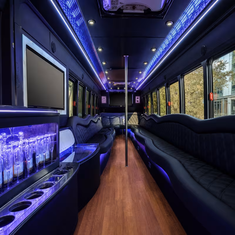 Party bus interior with wraparound leather seating and LED lighting in New Orleans