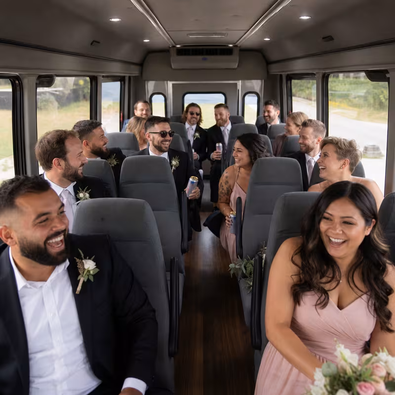 Group boarding a white charter bus for Wedding Transportation transportation in New Orleans