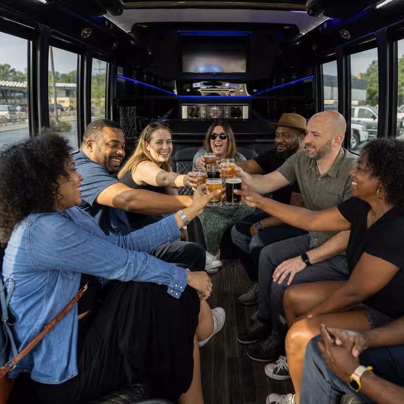 Group boarding a white charter bus for Winery & Brewery Tour Transportation transportation in New Orleans