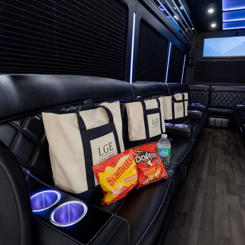 Party bus interior with wraparound leather seating and LED lighting in New Orleans